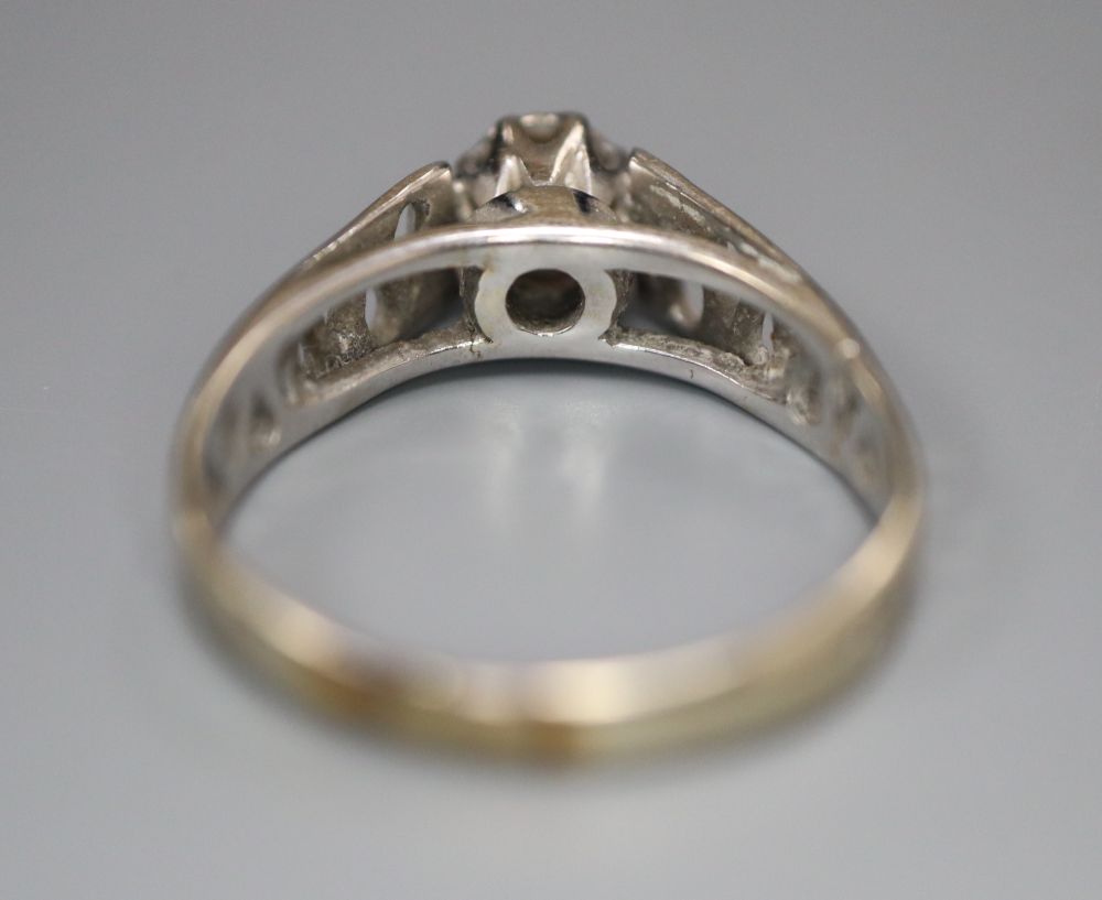 A diamond and 18ct white gold solitaire ring with pierced shank, size L/M, gross 2.9 grams.